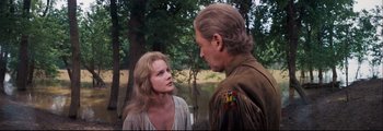 Movie still from “How the West Was Won” (1962), directed by George Marshall – A man and a woman standing next to each other in front of a body of water; Medium shot, Over the shoulder angle