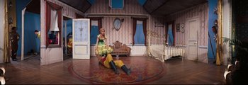 Movie still from “How the West Was Won” (1962), directed by George Marshall – A man and a woman are sitting on the floor of a living room; Wide shot, Overhead angle