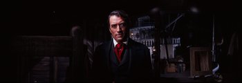 Movie still from “How the West Was Won” (1962), directed by George Marshall – A man wearing a suit and red neck tie; Close Up shot, Low angle