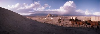 Movie still from “How the West Was Won” (1962), directed by George Marshall – Two men on horseback riding through a desert; Extreme Wide shot, Low angle