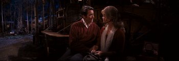 Movie still from “How the West Was Won” (1962), directed by George Marshall – A man and a woman sitting next to each other; Medium shot, Over the shoulder angle