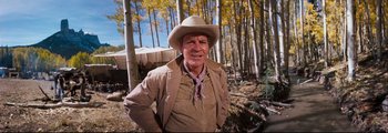 Movie still from “How the West Was Won” (1962), directed by George Marshall – An older man wearing a cowboy hat in the woods; Medium shot, Low angle