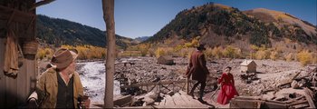 Movie still from “How the West Was Won” (1962), directed by George Marshall – A man in a red coat walking on a rocky path; Extreme Wide shot, High angle