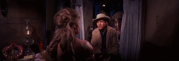 Movie still from “How the West Was Won” (1962), directed by George Marshall – A man and a woman sitting in front of each other; Medium shot, Over the shoulder angle