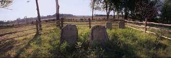 Movie still from “How the West Was Won” (1962), directed by George Marshall – A couple of stone markers sitting in the middle of a field; Wide shot, Low angle