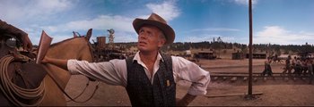 Movie still from “How the West Was Won” (1962), directed by George Marshall – An older man wearing a cowboy hat in a field; Medium shot, Low angle