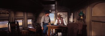 Movie still from “How the West Was Won” (1962), directed by George Marshall – A man and a man standing next to each other; Medium shot, Over the shoulder angle