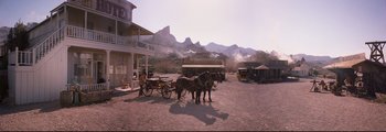 Movie still from “How the West Was Won” (1962), directed by George Marshall – Two horses are pulling a carriage down the street; Extreme Wide shot, High angle
