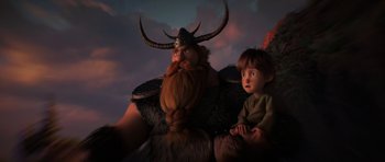 Movie still from “How to Train Your Dragon: The Hidden World” (2019), directed by Dean DeBlois – A young boy sitting next to an animated character; Medium shot, Low angle