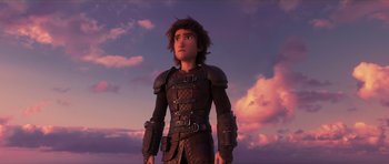 Movie still from “How to Train Your Dragon: The Hidden World” (2019), directed by Dean DeBlois – A man in a leather outfit standing in front of the sky; Medium shot, Low angle