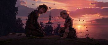 Movie still from “How to Train Your Dragon: The Hidden World” (2019), directed by Dean DeBlois – A couple of people sitting on top of a hill; Wide shot, Low angle