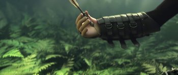 Movie still from “How to Train Your Dragon: The Hidden World” (2019), directed by Dean DeBlois – An arm holding an arrow in a jungle setting; Close Up shot, Low angle