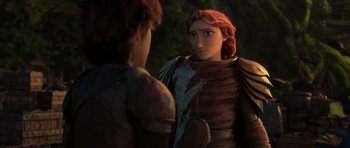 Movie still from “How to Train Your Dragon: The Hidden World” (2019), directed by Dean DeBlois – A woman in red is looking into a mirror while a man in brown is standing next to her; Medium shot, Over the shoulder angle
