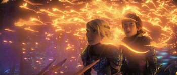 Movie still from “How to Train Your Dragon: The Hidden World” (2019), directed by Dean DeBlois – Two people are standing next to each other in front of fire; Medium shot, Over the shoulder angle