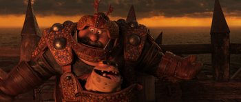 Movie still from “How to Train Your Dragon: The Hidden World” (2019), directed by Dean DeBlois – A man in a helmet and armor holding a dog; Medium shot, Low angle