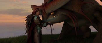 Movie still from “How to Train Your Dragon: The Hidden World” (2019), directed by Dean DeBlois – A woman is holding the hand of a large dragon; Wide shot, Over the shoulder angle