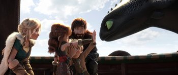 Movie still from “How to Train Your Dragon: The Hidden World” (2019), directed by Dean DeBlois – A group of people standing next to each other near a dragon; Medium shot, Over the shoulder angle
