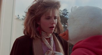 Movie still from “Howard the Duck” (1986), directed by Willard Huyck – A woman in a brown jacket and a white duck; Close Up shot, Over the shoulder angle