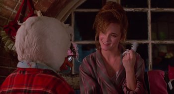 Movie still from “Howard the Duck” (1986), directed by Willard Huyck – A woman in pajamas holding a chicken and a cell phone in her hand; Close Up shot, Over the shoulder angle