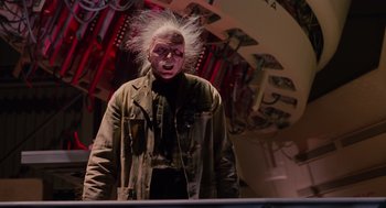 Movie still from “Howard the Duck” (1986), directed by Willard Huyck – A man with a white hair and a wig on his head; Medium shot, Low angle