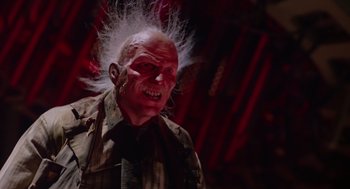 Movie still from “Howard the Duck” (1986), directed by Willard Huyck – An old man with white hair and a red face; Close Up shot, Low angle