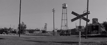 Movie still from “Hud” (1963), directed by Martin Ritt – A black and white photo of a water tower; Extreme Wide shot, Low angle