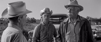 Movie still from “Hud” (1963), directed by Martin Ritt – Two men in cowboy hats standing in front of an old truck; Medium shot, Low angle