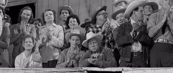 Movie still from “Hud” (1963), directed by Martin Ritt – A group of men and women wearing cowboy hats; Medium shot, High angle