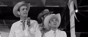 Movie still from “Hud” (1963), directed by Martin Ritt – A black - and - white photo of three men wearing cowboy hats; Close Up shot, Low angle