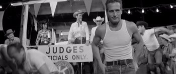 Movie still from “Hud” (1963), directed by Martin Ritt – A black and white photo of a man wearing a cowboy hat; Medium shot, Over the shoulder angle