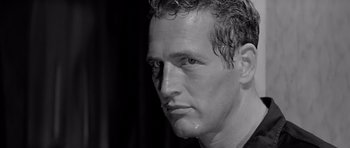 Movie still from “Hud” (1963), directed by Martin Ritt – Black and white photograph of a man's face with water on his face; Close Up shot, Low angle