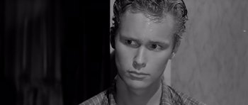 Movie still from “Hud” (1963), directed by Martin Ritt – Black and white photograph of a young man with wet hair; Close Up shot, Low angle
