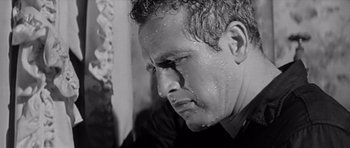 Movie still from “Hud” (1963), directed by Martin Ritt – Black and white photograph of a man with sweat all over his face; Close Up shot, Low angle