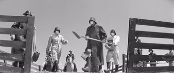 Movie still from “Hud” (1963), directed by Martin Ritt – A black and white photo of a group of people; Wide shot, Low angle