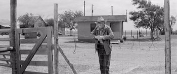 Movie still from “Hud” (1963), directed by Martin Ritt – An old man in a cowboy hat standing next to barbed wire; Medium shot, Low angle