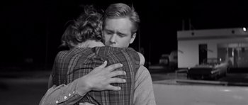 Movie still from “Hud” (1963), directed by Martin Ritt – A man and a woman hugging each other in a black and white photo; Close Up shot, Over the shoulder angle