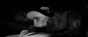 Movie still from “Hud” (1963), directed by Martin Ritt – A black and white photo of a man wearing a cowboy hat; Close Up shot, Low angle