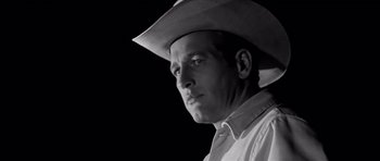 Movie still from “Hud” (1963), directed by Martin Ritt – A black and white photo of a man wearing a cowboy hat; Close Up shot, Low angle