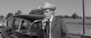Movie still from “Hud” (1963), directed by Martin Ritt – A black and white photo of a man wearing a cowboy hat; Medium shot, Low angle