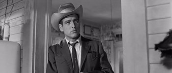 Movie still from “Hud” (1963), directed by Martin Ritt – A black and white photo of a man wearing a cowboy hat; Close Up shot, Low angle