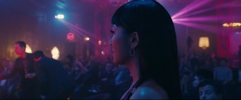 Movie still from “Hustlers” (2019), directed by Lorene Scafaria – A woman with long black hair is in a dark room; Close Up shot, Over the shoulder angle