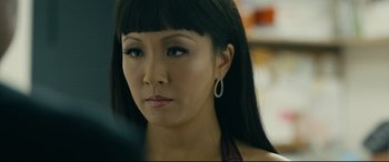 Movie still from “Hustlers” (2019), directed by Lorene Scafaria – A person with long black hair; Close Up shot, Over the shoulder angle