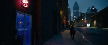 Movie still from “Hustlers” (2019), directed by Lorene Scafaria – A woman walking down a sidewalk at night; Extreme Wide shot, Low angle