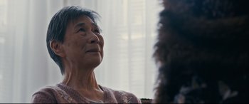 Movie still from “Hustlers” (2019), directed by Lorene Scafaria – An older woman sitting in front of a window looking up; Close Up shot, Over the shoulder angle