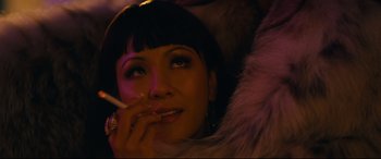 Movie still from “Hustlers” (2019), directed by Lorene Scafaria – A woman is smoking a cigarette while wearing a fur coat; Close Up shot, Over the shoulder angle