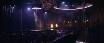 Movie still from “Hustlers” (2019), directed by Lorene Scafaria – A woman is performing on a pole in a dark room; Extreme Wide shot, Low angle