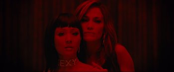 Movie still from “Hustlers” (2019), directed by Lorene Scafaria – Two women posing for a picture in a dark room; Close Up shot, Overhead angle