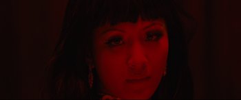 Movie still from “Hustlers” (2019), directed by Lorene Scafaria – A woman's face in the dark; Extreme Close Up shot, Low angle