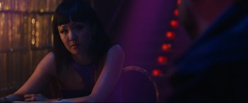 Movie still from “Hustlers” (2019), directed by Lorene Scafaria – A woman sitting on a chair in a dark room; Close Up shot, Over the shoulder angle