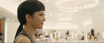 Movie still from “Hustlers” (2019), directed by Lorene Scafaria – A person with short black hair; Close Up shot, Over the shoulder angle